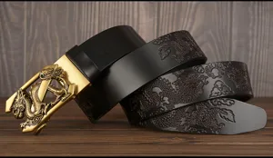 Detailed view of black leather men's belt with embossed dragon patterns and golden buckle.