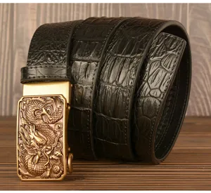 Detail view of men's leather belt with crocodile pattern and golden dragon automatic buckle.