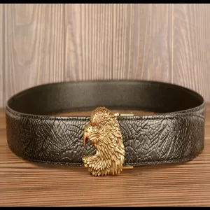 Detailed view of men leather belt with golden eagle head metal buckle, stylish black strap.