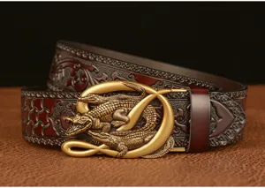 Close-up of retro men leather belt with intricate carved patterns and metallic crocodile buckle.