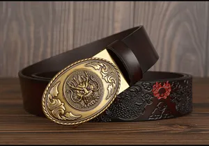 Close-up of men's leather belt detail, featuring embossed dragon pattern and metal buckle.
