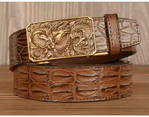 Men's leather belt detail, embossed crocodile pattern cowhide strap with dragon buckle.