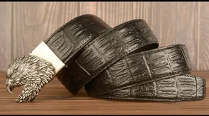 Closeup detail of the men's retro leather belt featuring a metallic eagle head buckle.