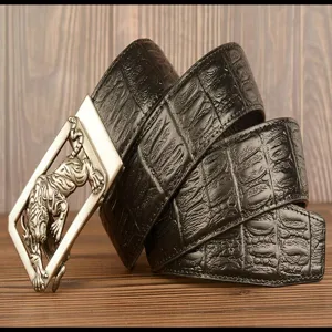Detail view of mens leather belt with automatic tiger buckle and black cowhide texture.