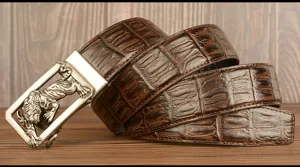 Men brown crocodile pattern leather belt with tiger automatic buckle, detail view.
