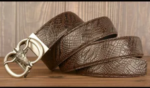 Detailed close-up of brown cowhide men's belt with retro bull head buckle and snakeskin pattern.