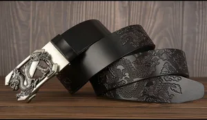 Close-up detail of the men's leather belt featuring embossed dragon pattern and metal buckle.