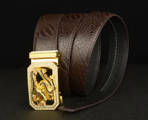 Close-up of luxury mens leather belt with gold dragon automatic buckle and rhinestone details.