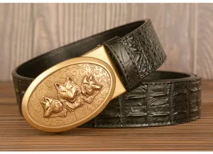 Detail view of men's leather belt with retro three wolf head buckle and crocodile pattern
