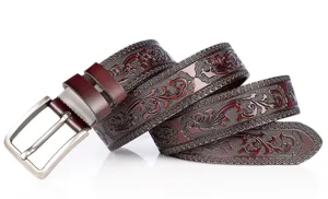 Detailed view of stylish men embossed leather belt with vintage floral carved pattern and buckle.