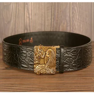 Men's leather belt detail view featuring crocodile pattern cowhide strap and vintage eagle automatic buckle.