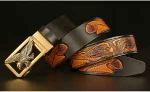 Close-up view of the men's leather belt featuring a detailed carved eagle design.