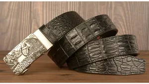 Details of the men's automatic buckle belt featuring black embossed leather and eagle metal.