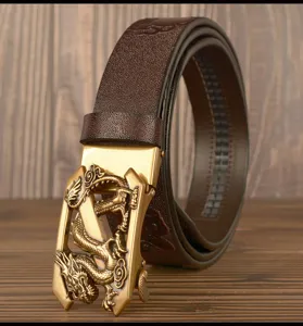 Detailed view of men's leather belt with golden 3D dragon buckle and embossed pattern.