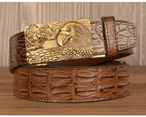 Detail view of men's brown crocodile texture leather belt with vintage eagle brass automatic buckle.