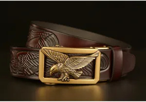Detailed view of the men's leather belt with intricate eagle embossing and golden buckle.
