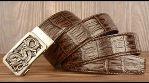 Detailed view of men's genuine leather belt featuring embossed crocodile pattern and dragon buckle.