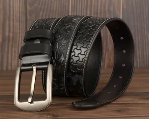 Detailed view of men's carved genuine leather belt with embossed pattern and sturdy metal buckle.