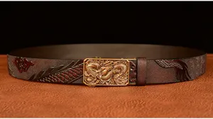 Detail view of mens embossed dragon leather belt with golden automatic buckle close up.