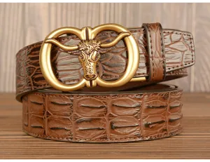 Detailed view of brown crocodile pattern leather belt with vintage metal bull head buckle style.