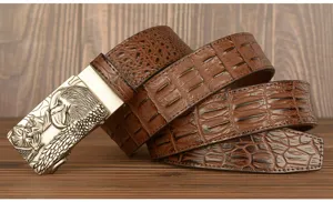 Detailed view of the vintage men leather belt with eagle buckle and crocodile texture pattern.