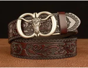 Detailed view of men's genuine leather belt featuring an intricate bull head buckle and embossed pattern.