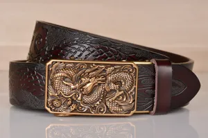 Detail shot of men's leather belt with intricate dragon embossed pattern and metal automatic buckle.