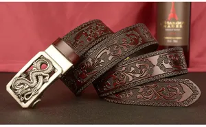 Men's embossed leather belt detail showing intricate dragon buckle and vintage floral carved strap design.