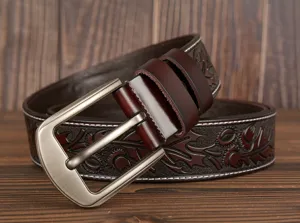 Detailed view of men's vintage brown embossed floral leather belt with stylish metal buckle.