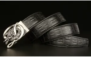 Close-up detail view of men's black leather belt featuring crocodile pattern and metal buckle.