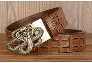 Men's leather belt with metallic cobra snake buckle and detailed crocodile pattern texture.