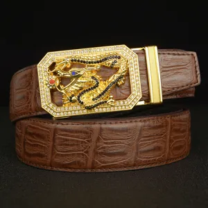 Men's leather belt featuring a gold rhinestone dragon automatic buckle and crocodile pattern.