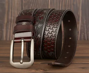 Close-up of embossed leather belt details, showing vintage carved patterns and metal buckle.