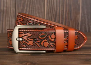Detailed view of men's embossed genuine leather carved belt casual retro metal buckle.