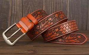 Detailed view of the vintage embossed men leather belt with floral carving and metal buckle.