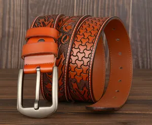 Detailed view of a brown embossed leather belt with intricate floral patterns and pin buckle.