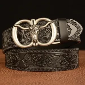 Men's leather belt with metal ox head buckle and embossed floral pattern for casual wear.