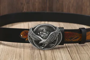 Detailed close-up of men's leather belt with retro eagle metal buckle and carved details.