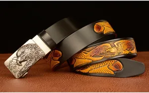 Men's leather belt detail view showcasing the intricate embossed eagle pattern and metallic buckle.