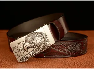 Detailed view of men's leather belt featuring eagle metal buckle and embossed eagle strap.