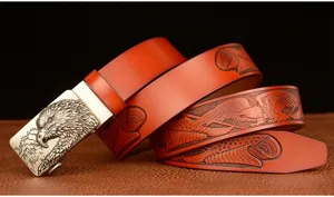 Leather belt detail showing the intricate eagle head buckle and embossed strap carving.