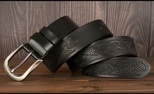Men's leather belt detail view featuring embossed eagle pattern and sturdy metal pin buckle.