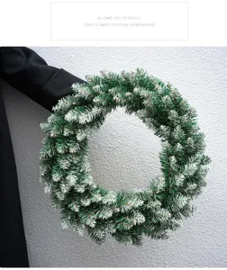 Snow-tipped green Christmas wreath detail shot, perfect for holiday door and tree hanging decor.