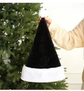 Detailed view of the black plush Christmas hat with white rolled brim and fluffy pompom.