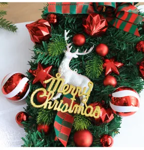 Christmas tree hanging decor detail view, featuring red ornaments, white elk and gold lettering.