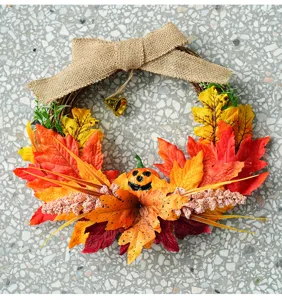 Autumn Halloween wreath hanging decor with maple leaves, burlap bow and cute pumpkin design.