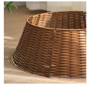 Detailed view of plastic rattan Christmas tree skirt, brown wicker tree collar base for holiday.