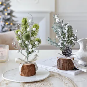Mini Christmas tree table decoration with wood base and white berries. Perfect for holiday home decor.