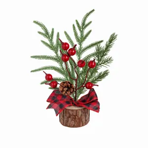 Mini Christmas tree detail with red berries, pinecone and plaid bow on wood base.