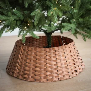 Close-up detail of a brown woven plastic Christmas tree collar base for holiday decor.